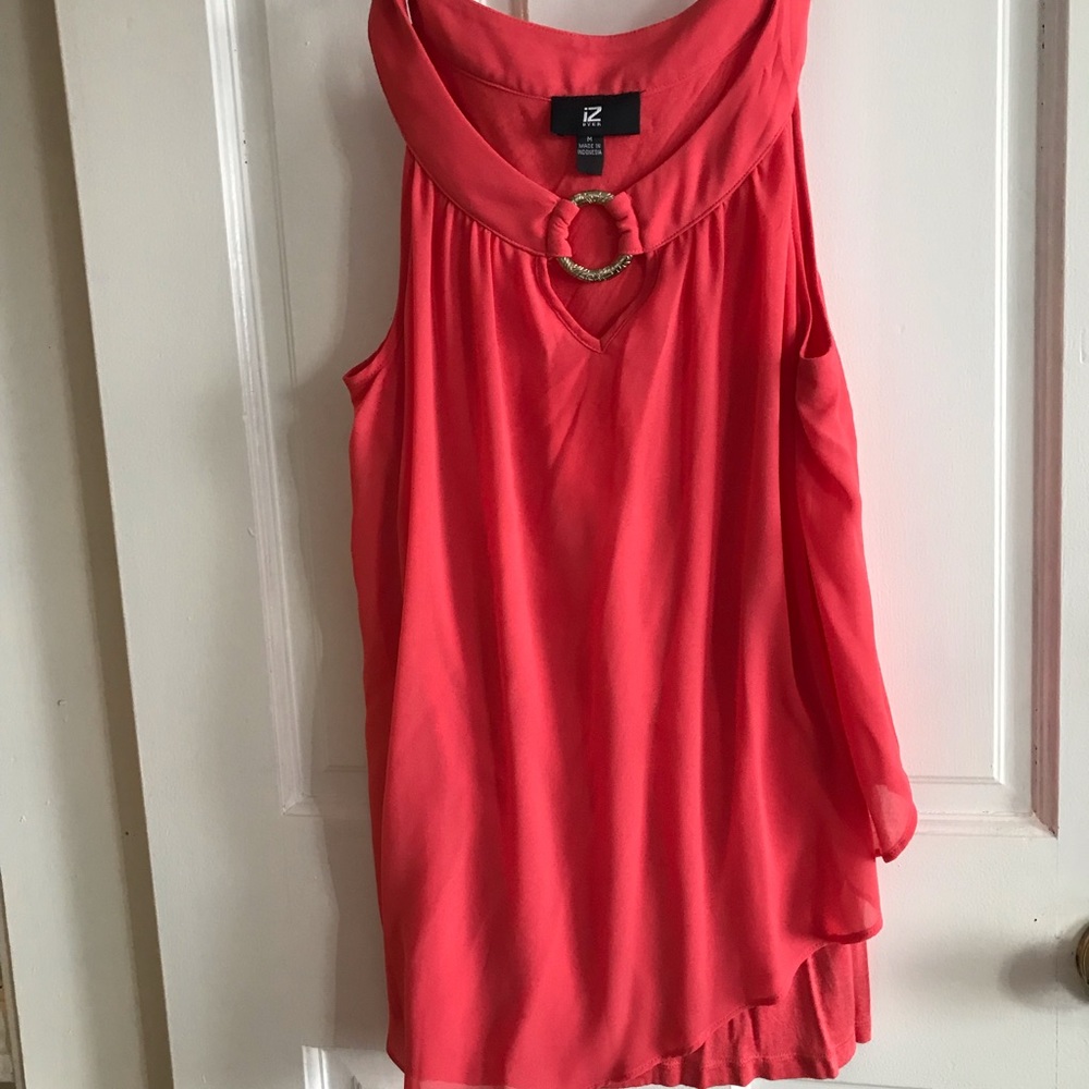 IZ Byer  size M color is more of a peachy/?coral color.